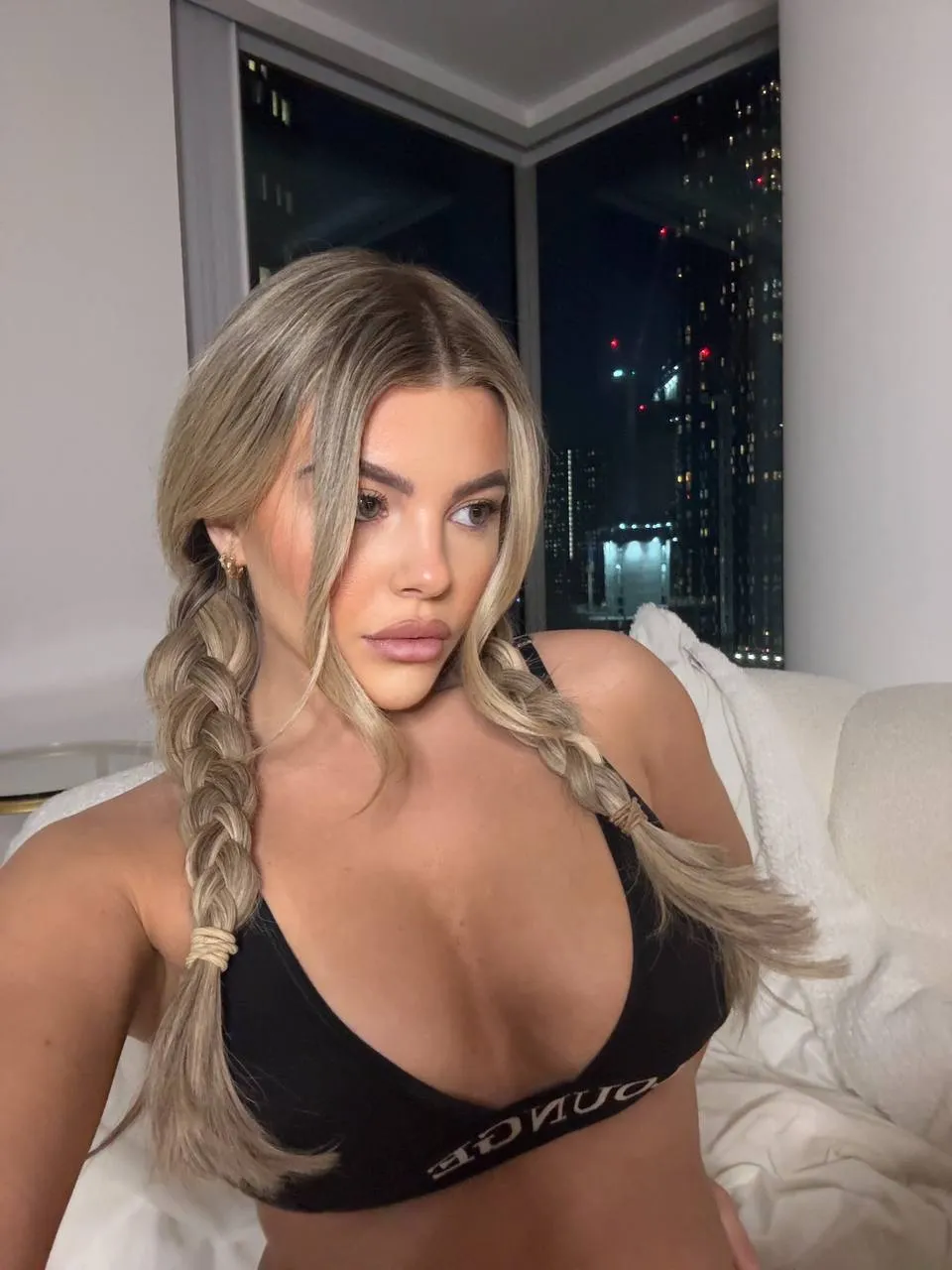 Onlyfans Model Tilly Harrington posing wearing black lingerie.